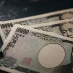 Japanese yen bills and currency symbol on a marble surface