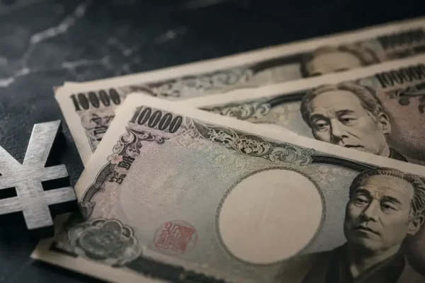 Japanese yen bills and currency symbol on a marble surface