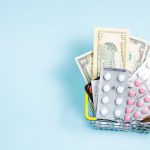 A shopping basket filled with various medications and cash, symbolizing healthcare expenses.