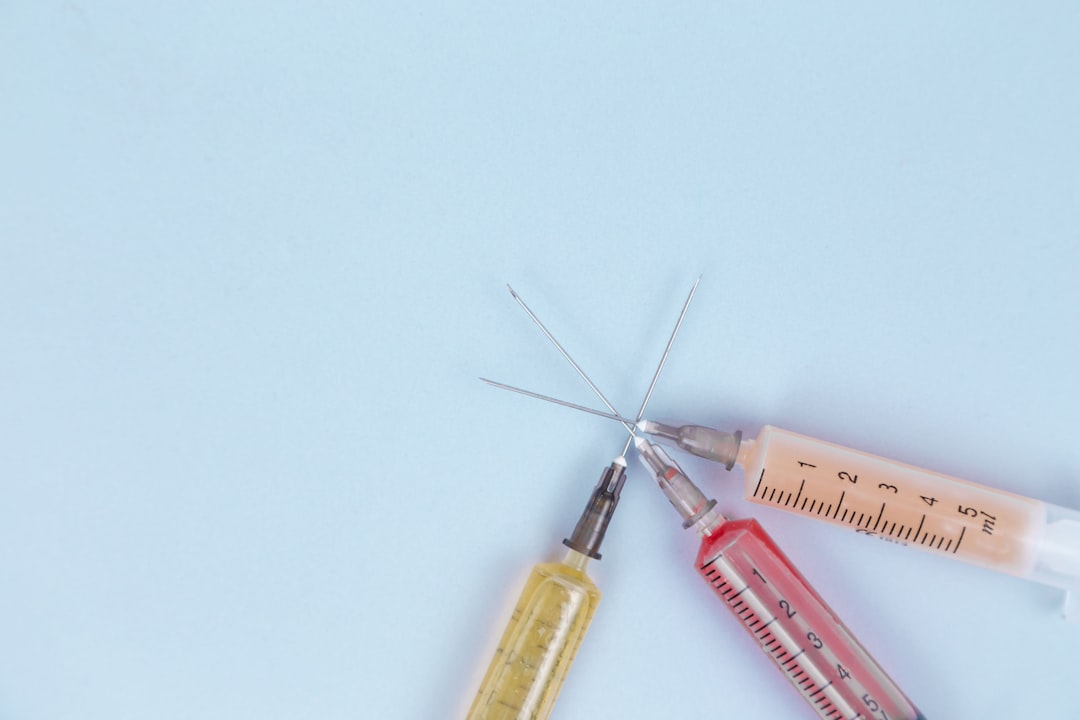 Three syringes on a light blue background