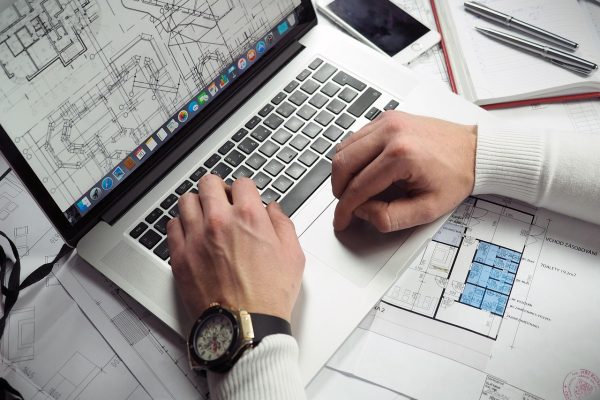 Blueprints, entrepreneur, hands — Fire Watch Services Near Me Offering Immediate Service and Certified Personnel