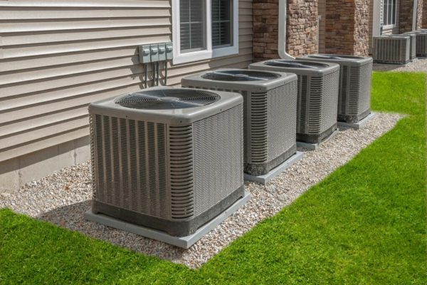 Multiple air conditioning units installed outside a house