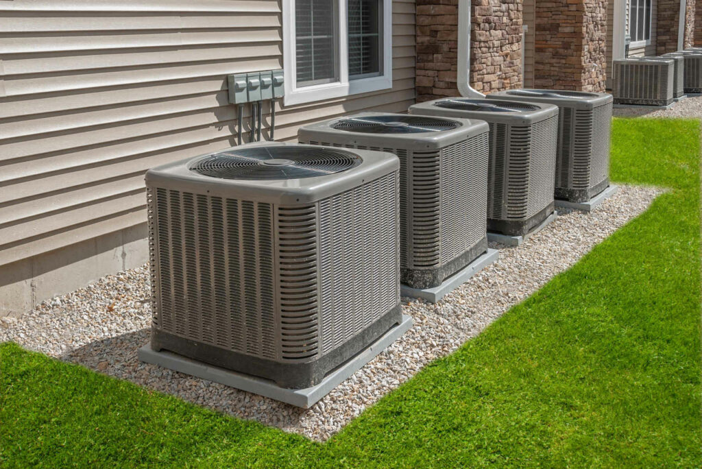 Multiple air conditioning units installed outside a house